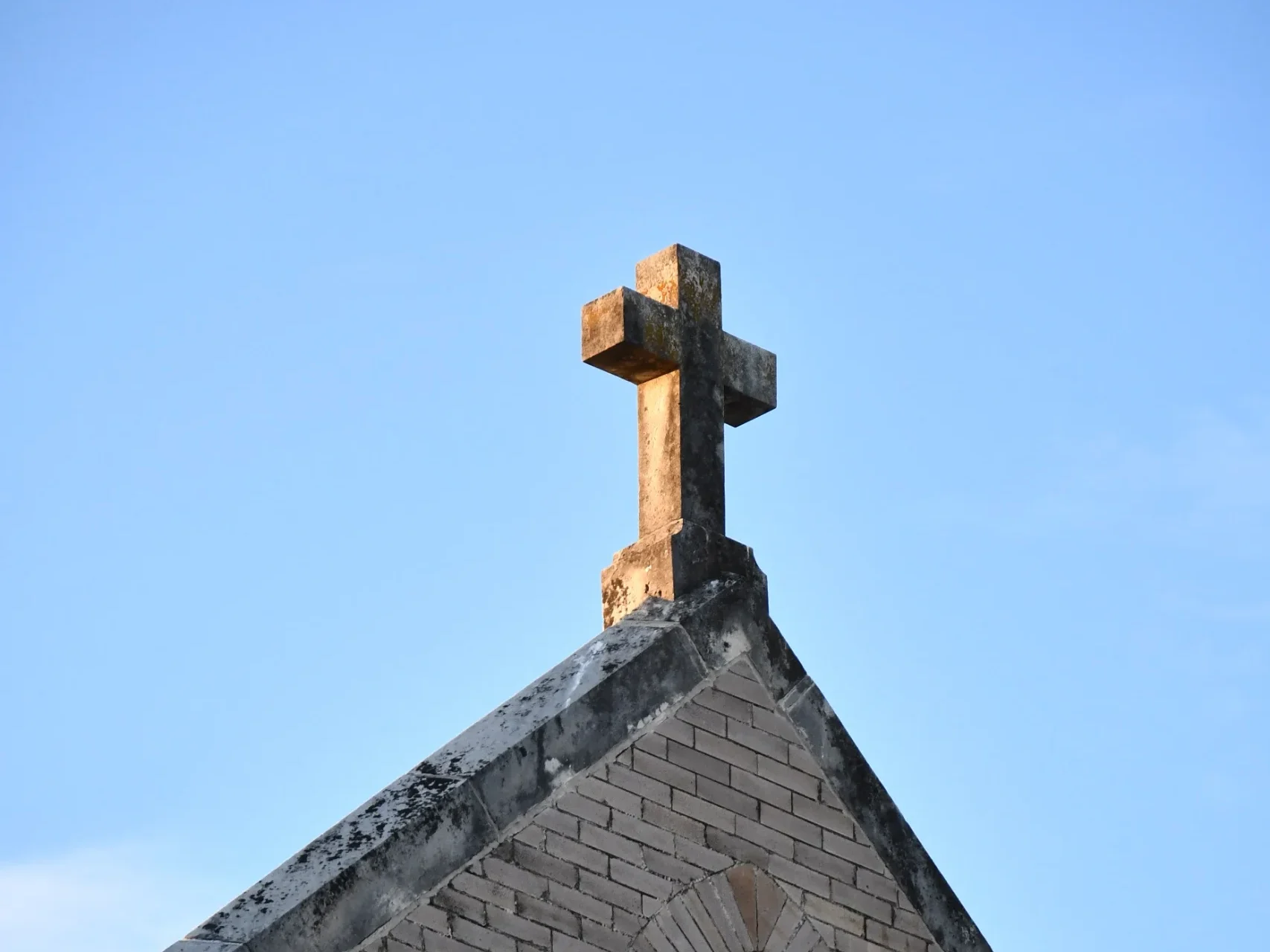 Stone cross atop a building